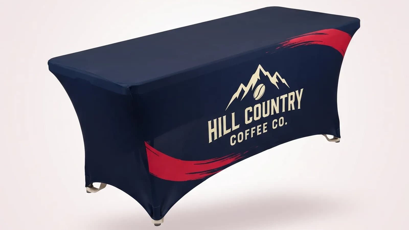 Close view of a printed table cover pulled over a folding table with a logo on the front