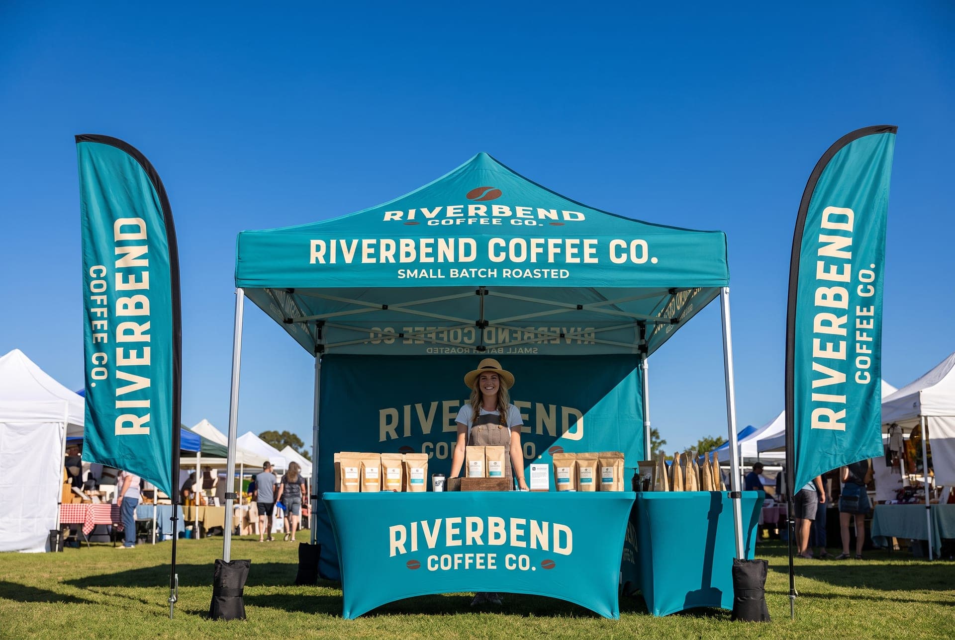 Riverbend Coffee Co. canopy tent package with printed walls, table throw and feather flags