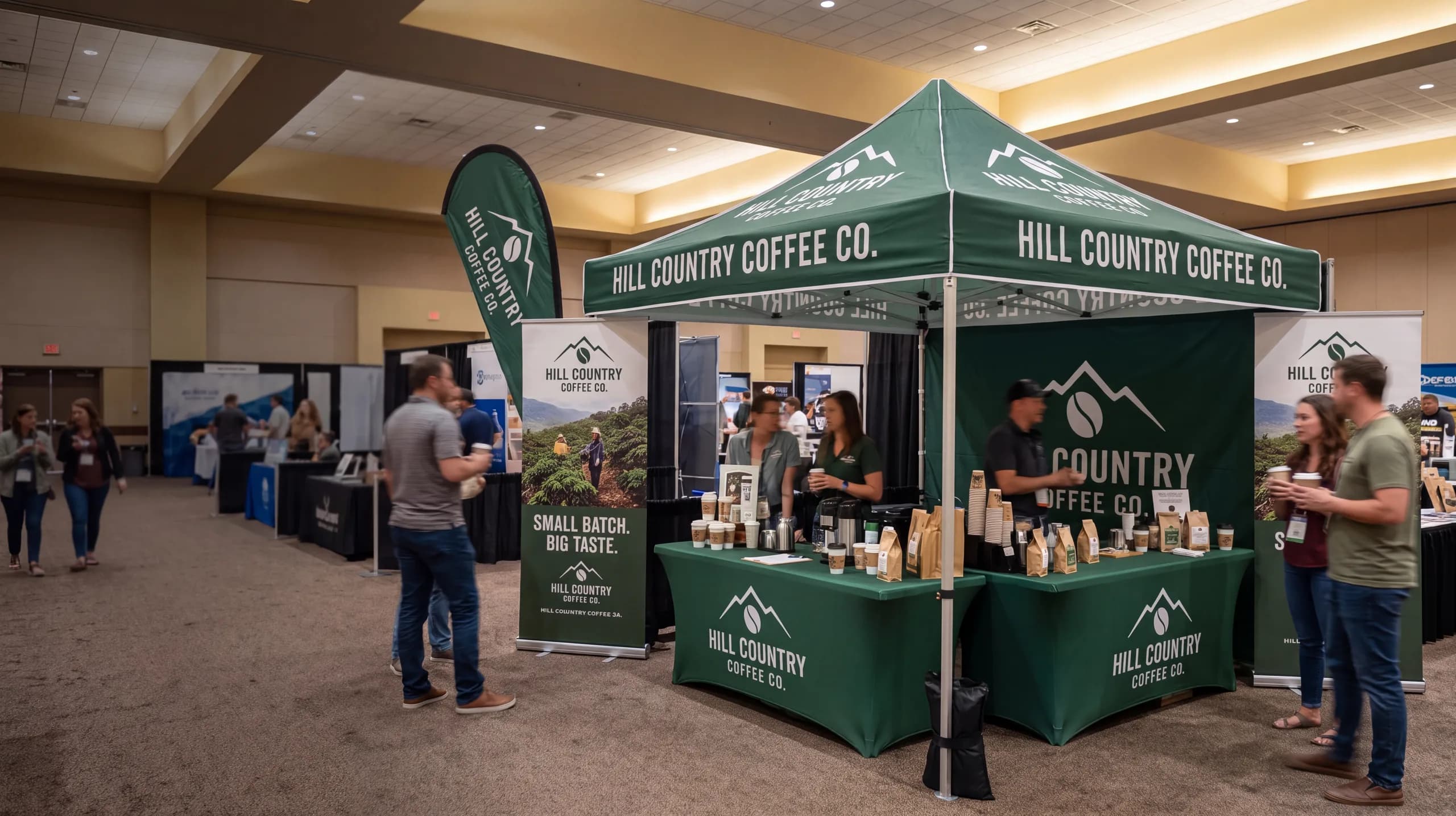 Expo booth with retractable banner stands, a branded canopy and printed table covers