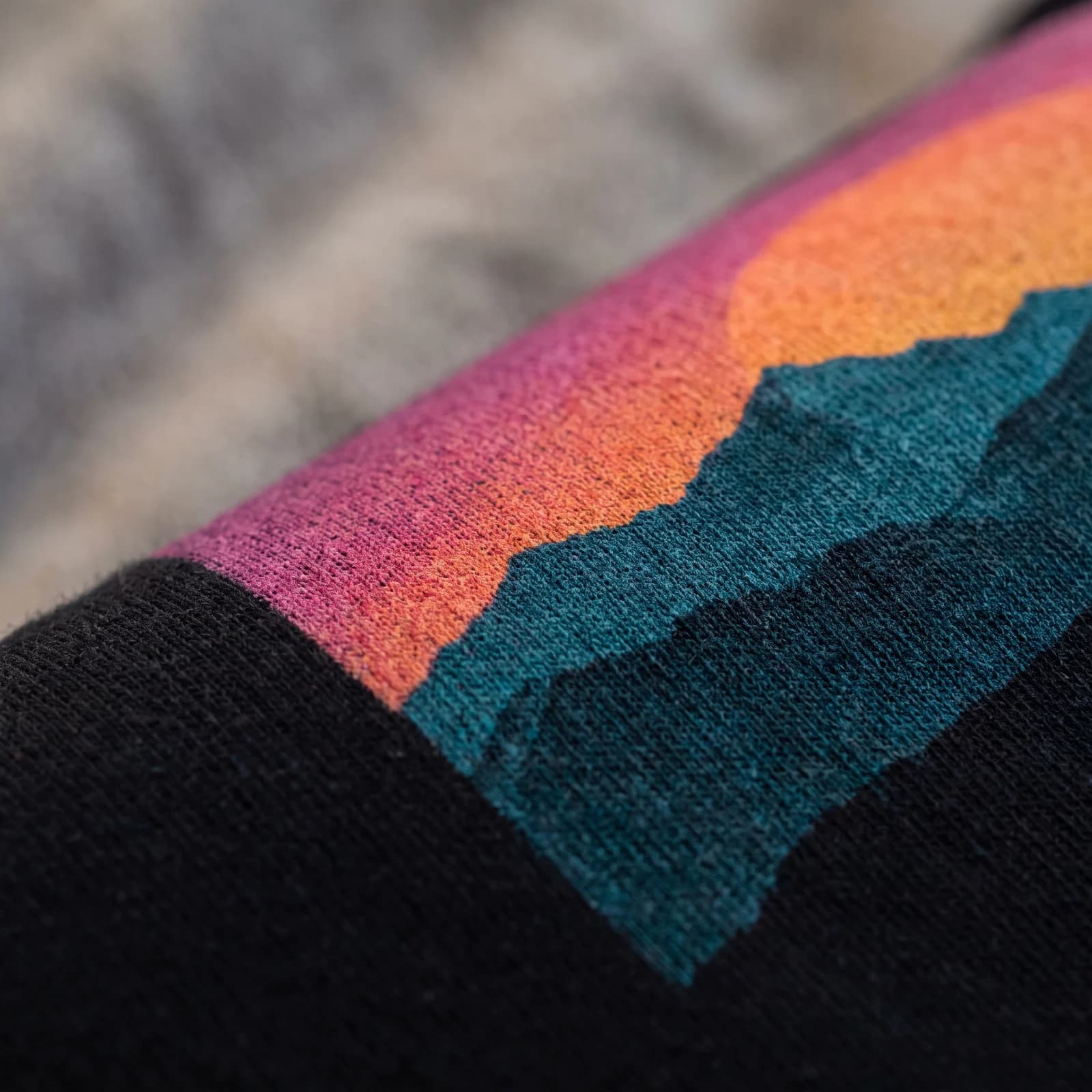 Close view of a full color mountain sunset print on black cotton