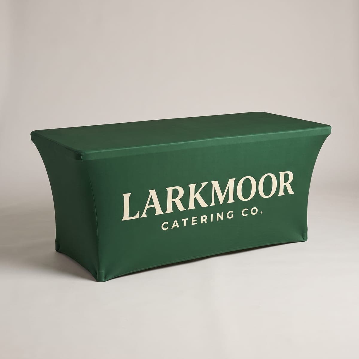Forest green Larkmoor Catering Co. fitted stretch table cover on a six foot table in a studio