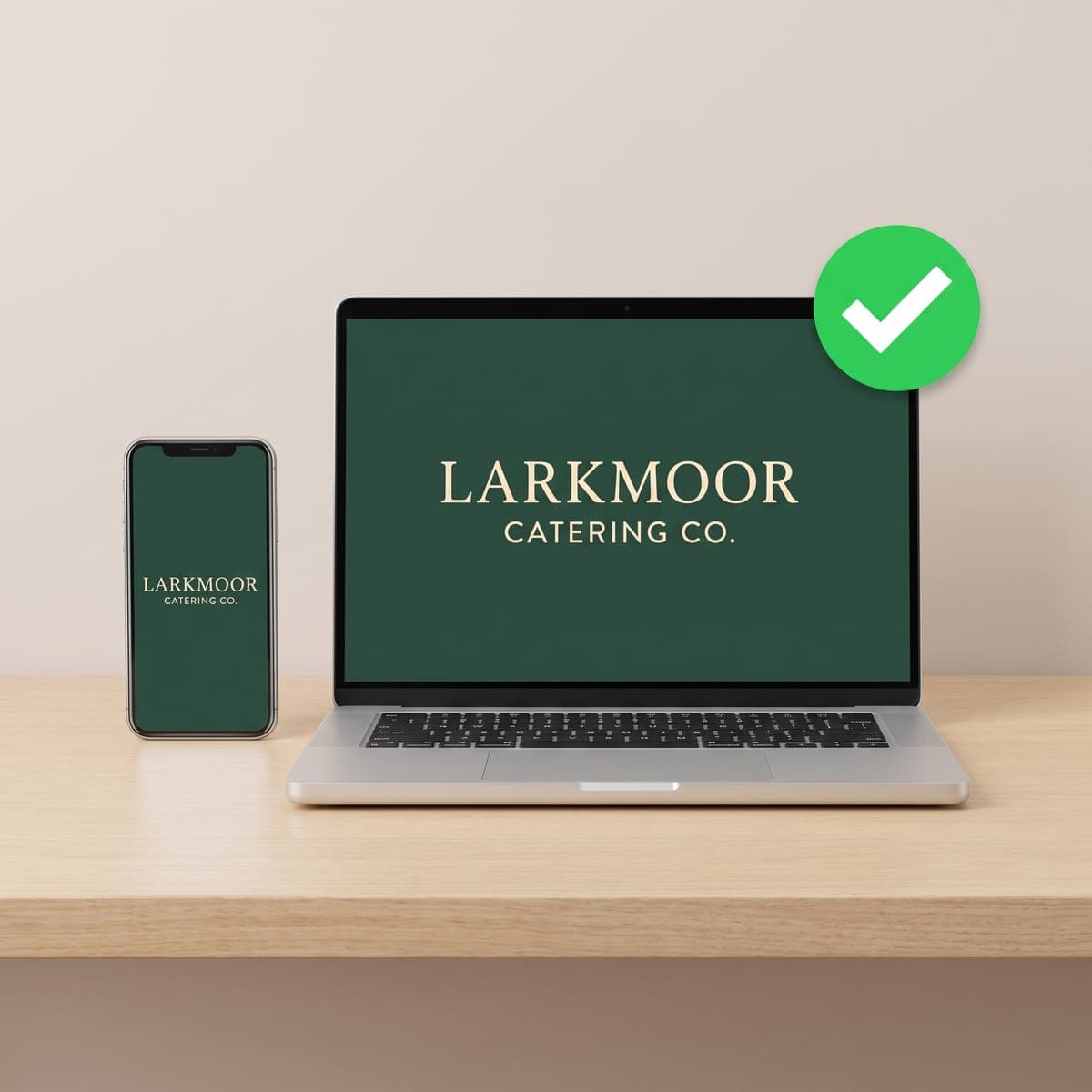 Laptop and phone showing the Larkmoor Catering Co. table cover proof with a green approval check