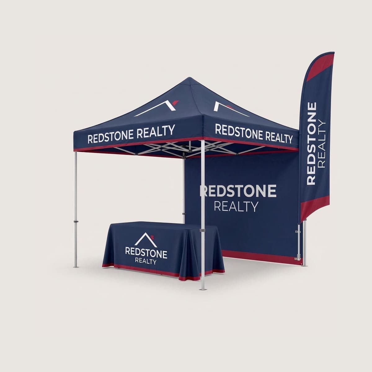Complete navy Redstone Realty canopy tent package with printed back wall, fitted table cover and feather flag in a studio