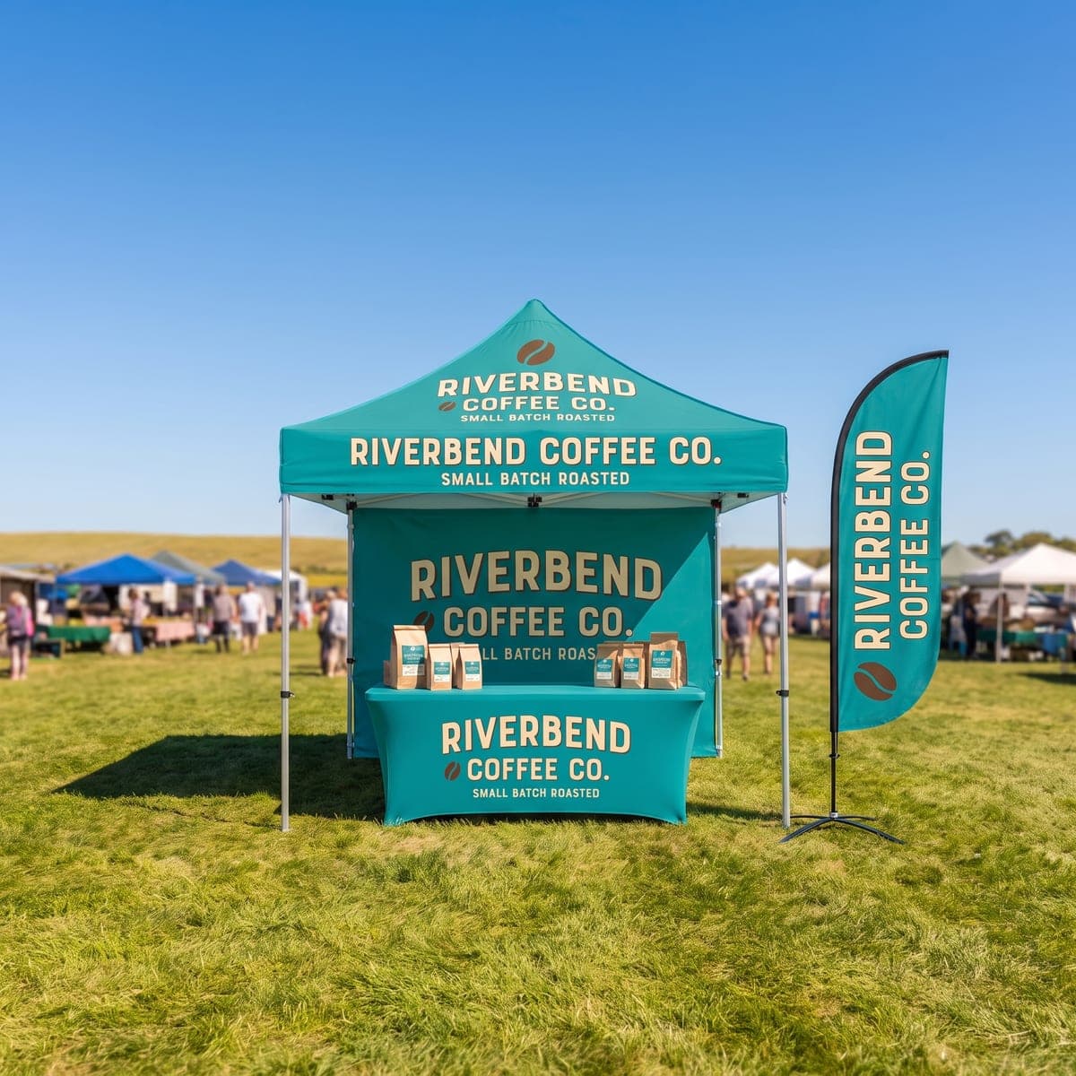 The finished Riverbend Coffee Co. canopy tent set up on grass at a sunny farmers market