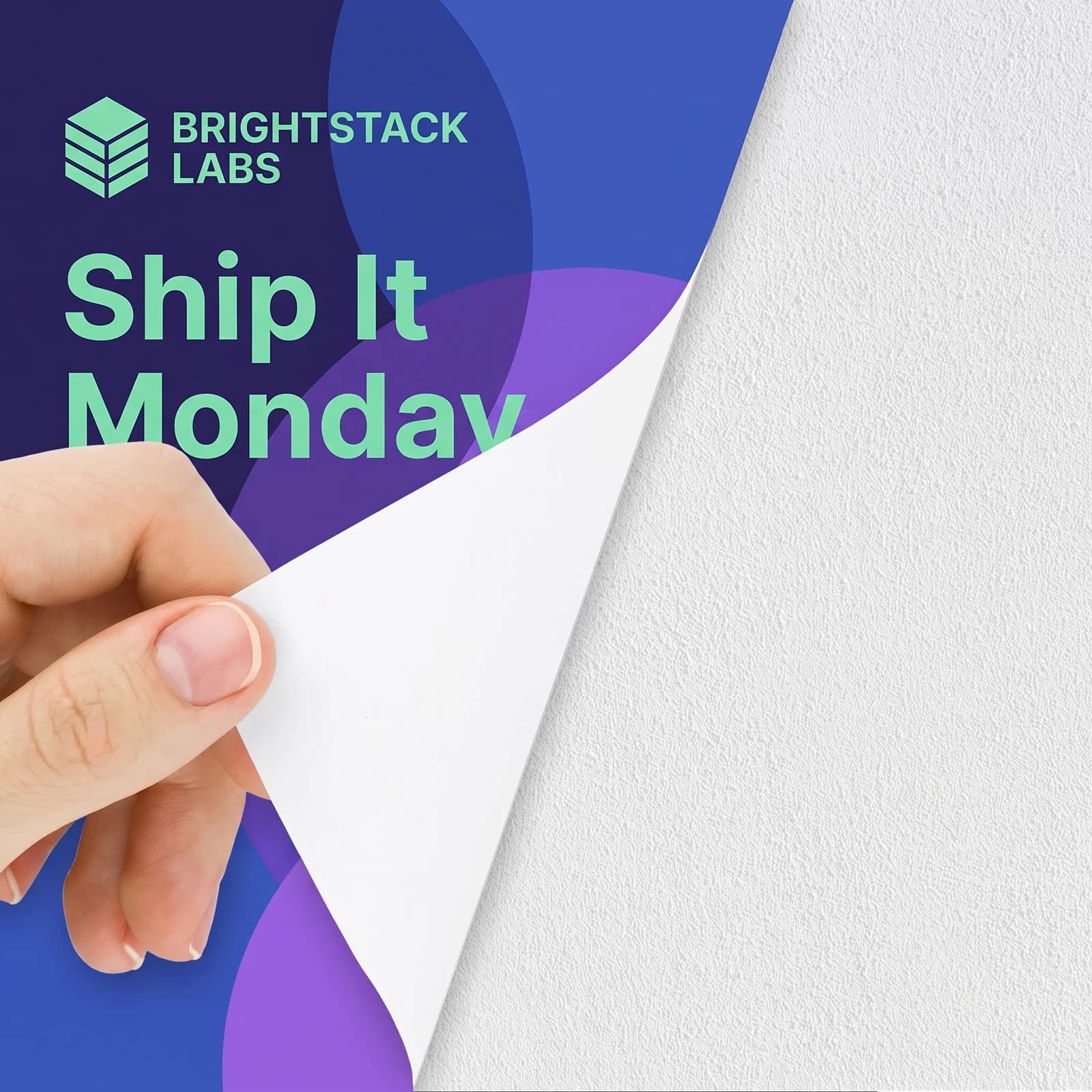 A hand peeling a Brightstack Labs wall graphic off a textured white wall, with the white fabric backing showing