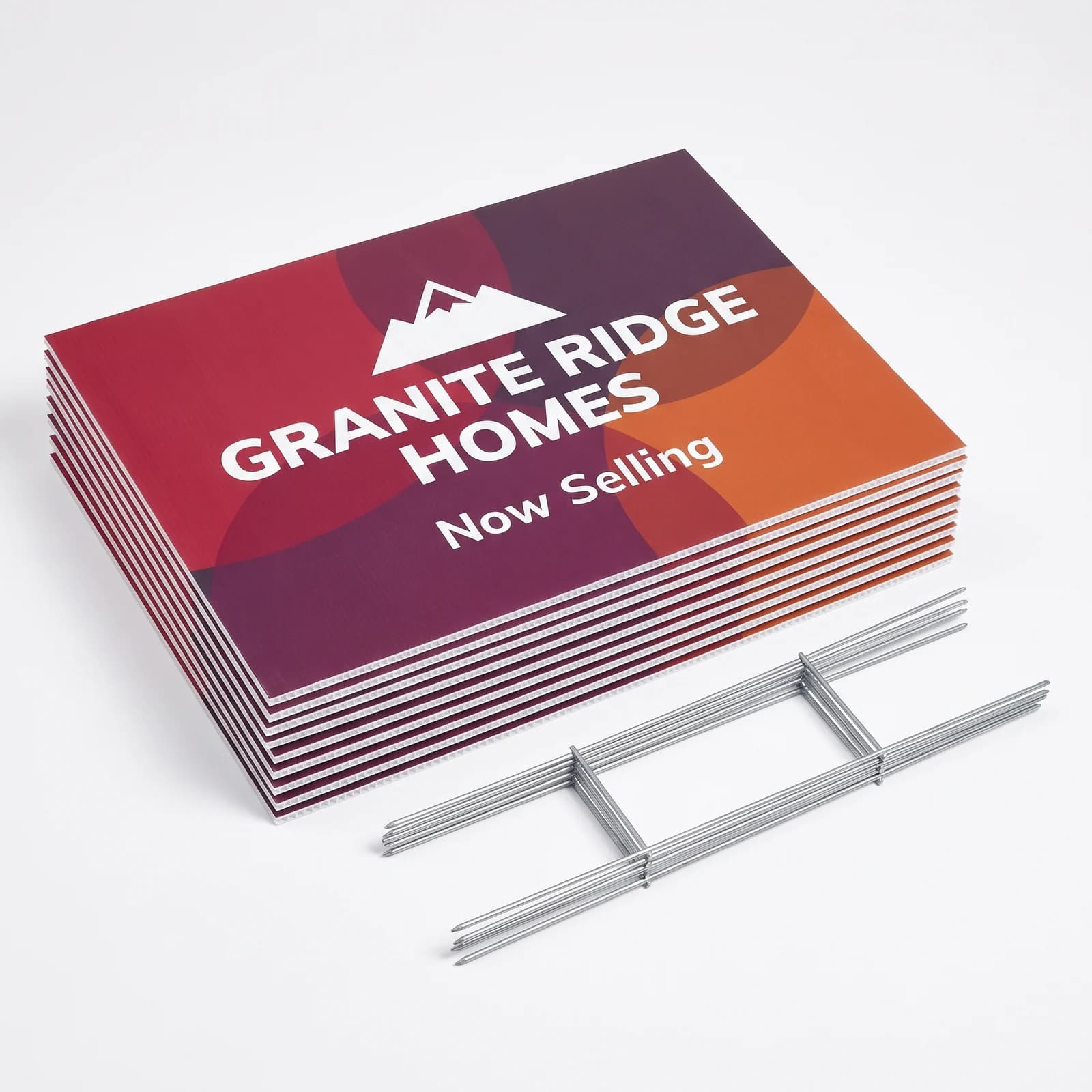 A stack of extra large double-sided landscape yard signs beside flat wire H-stakes
