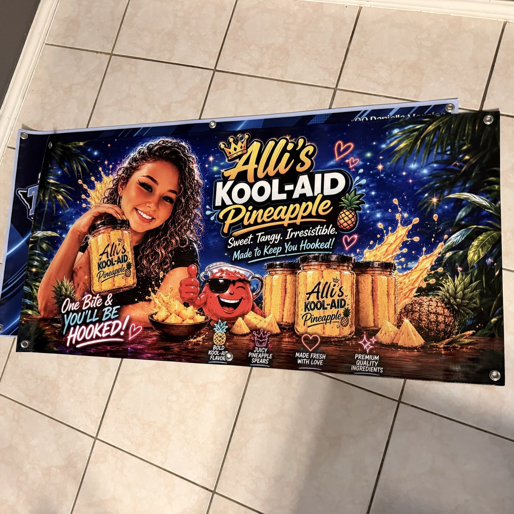 The same Alli's Kool-Aid banner laid flat, showing the full artwork and corner grommets
