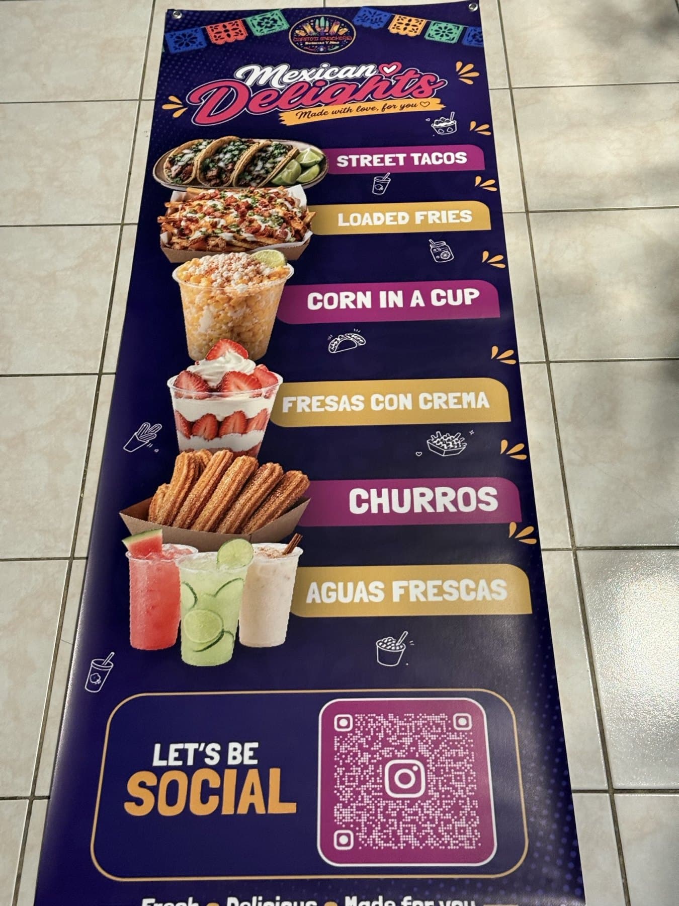Delivery photo of the Carito's Snackaria menu banner laid flat indoors before pickup