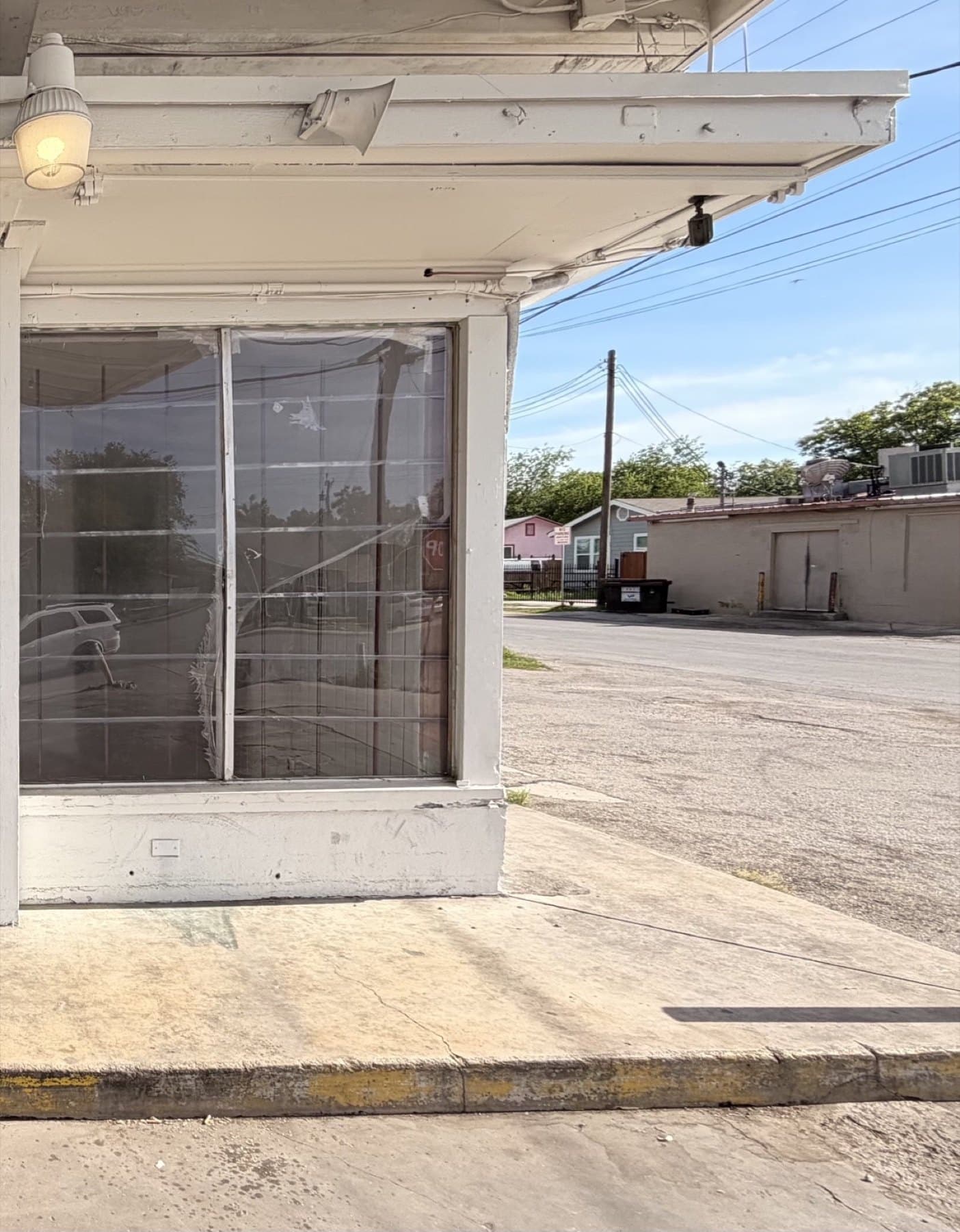 The same storefront before the rebrand, with bare glass and no signage of any kind