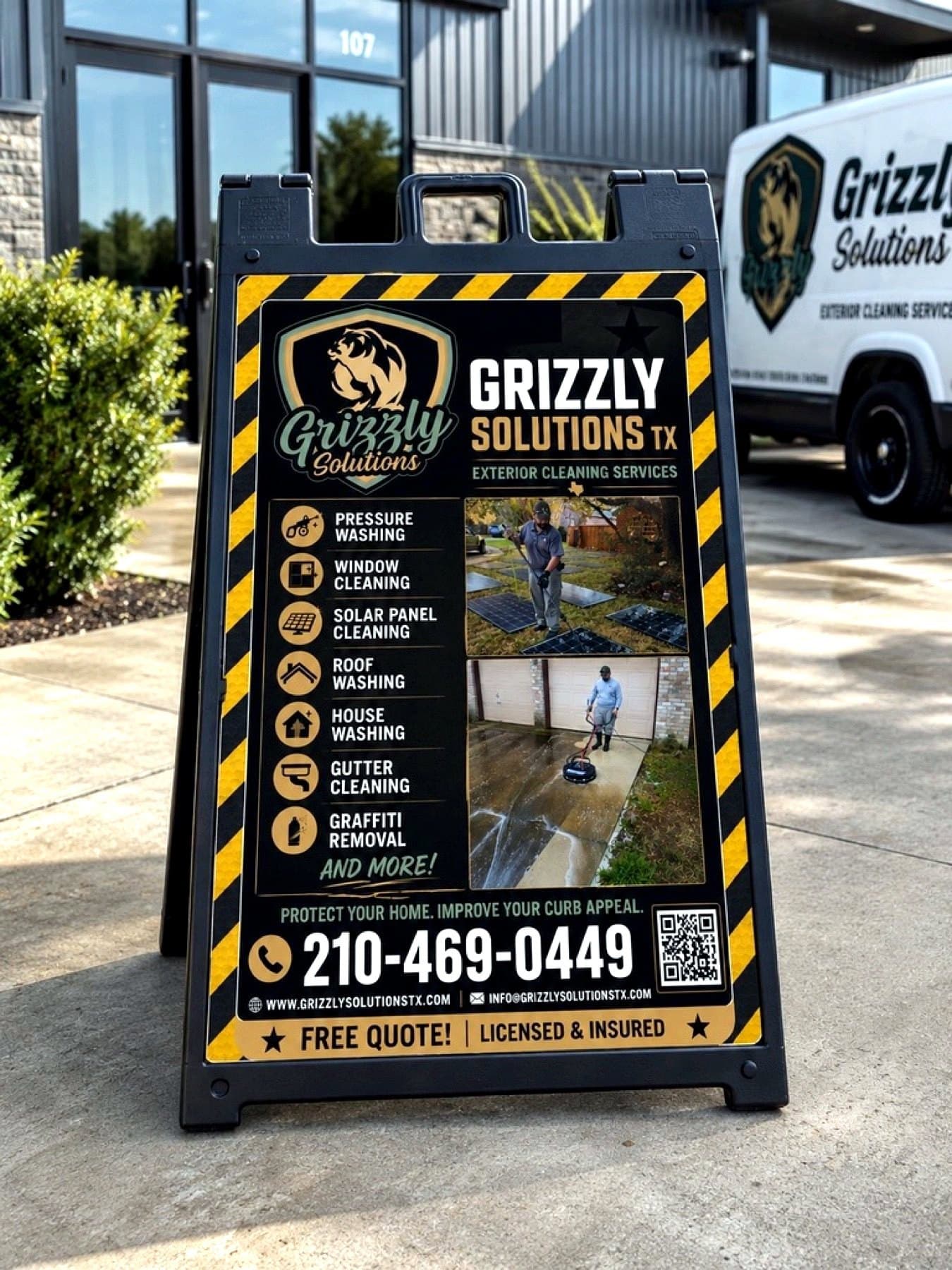 On-site photo of the Grizzly Solutions A-frame at the entrance beside the company van