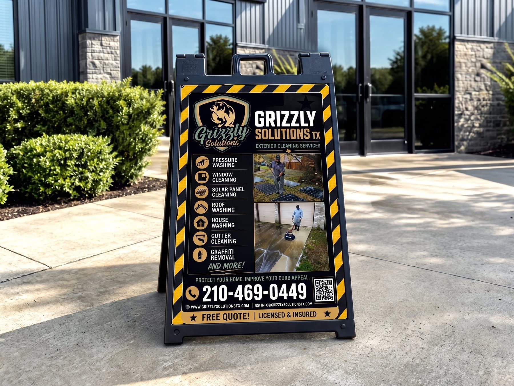 Grizzly Solutions A-frame sidewalk sign standing on a commercial walkway, seven services listed down the left with icons, two job photographs down the right and the phone number in the largest type on the panel