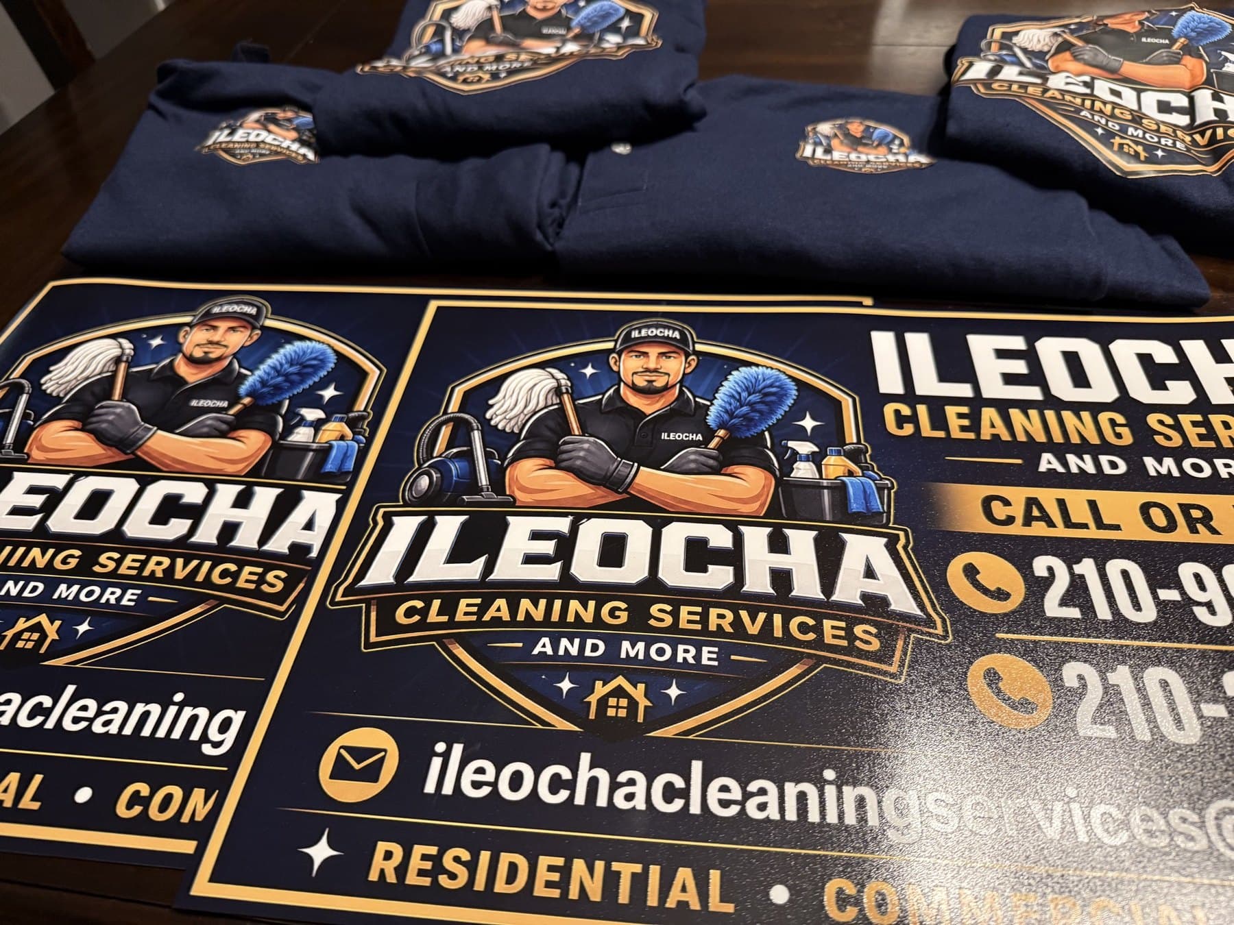 A closer view of the finished Ileocha magnets stacked in front of the folded crew shirts