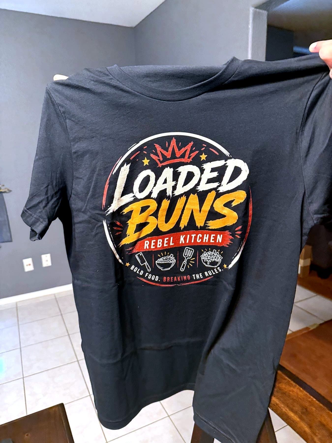 Delivery photo of the Loaded Buns crew shirt held open after printing