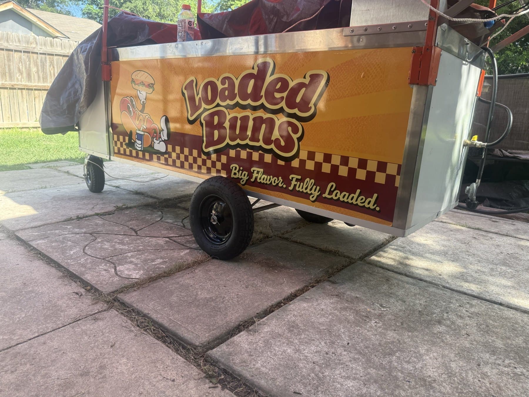 The lower panel of the finished Loaded Buns cart, showing the checker border and tagline