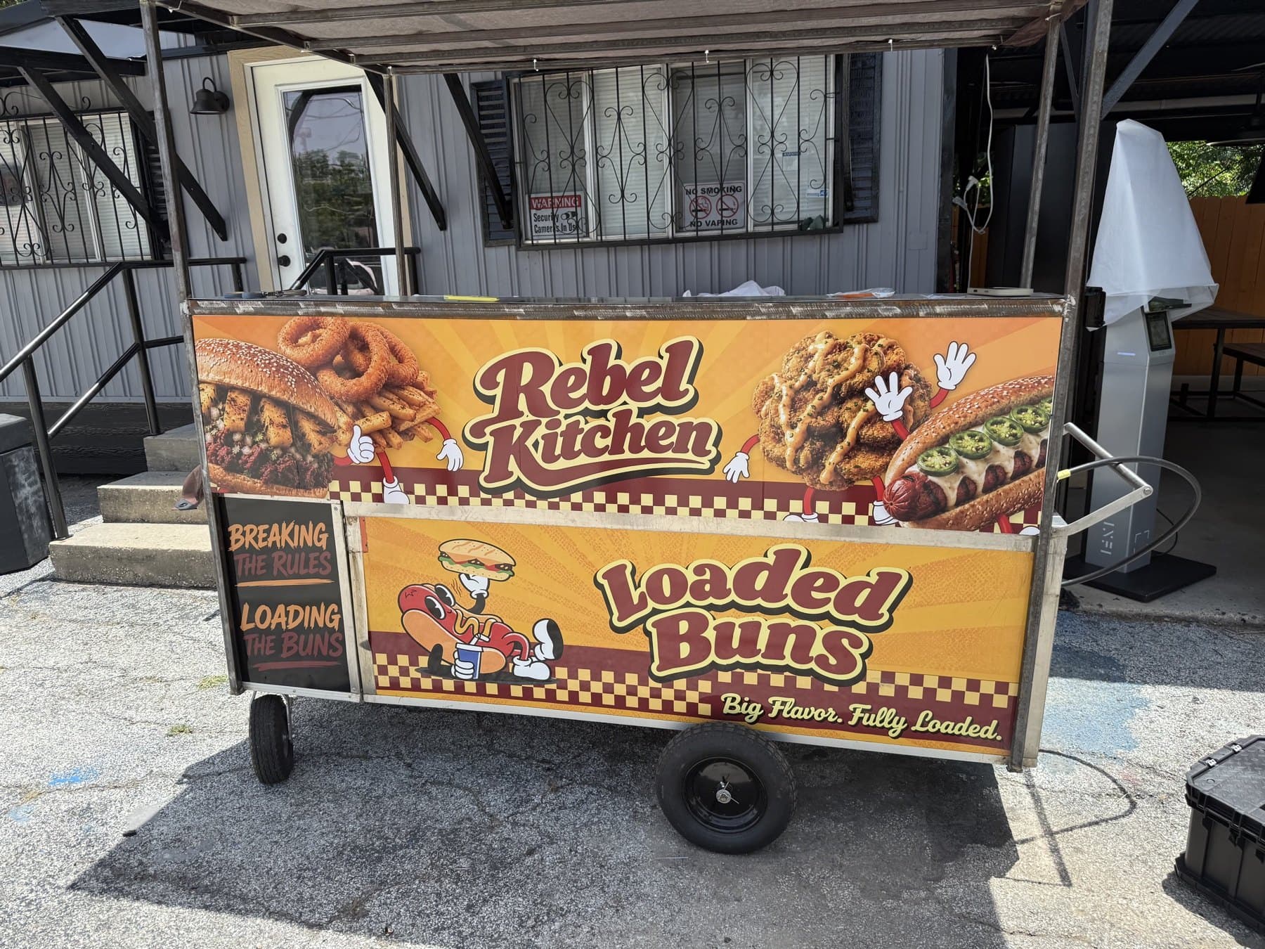 Loaded Buns cart from the front corner showing the Rebel Kitchen panel and the side graphic together