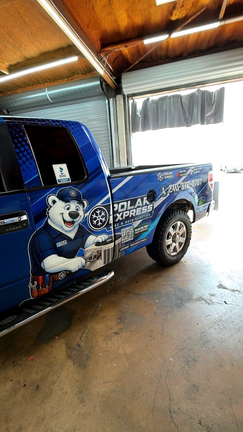 Polar Express HVAC and Refrigeration truck wrap with a polar bear technician illustration on the door