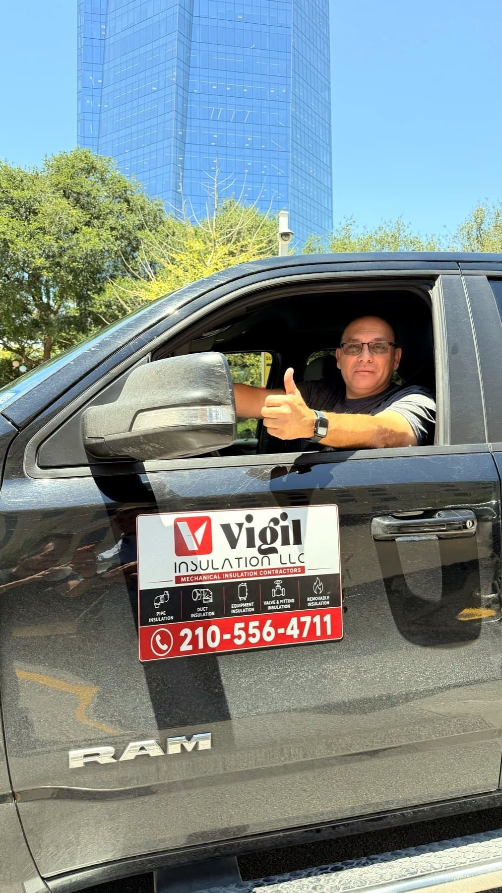 On-site photo of the Vigil Insulation magnet on the truck with the owner in the cab