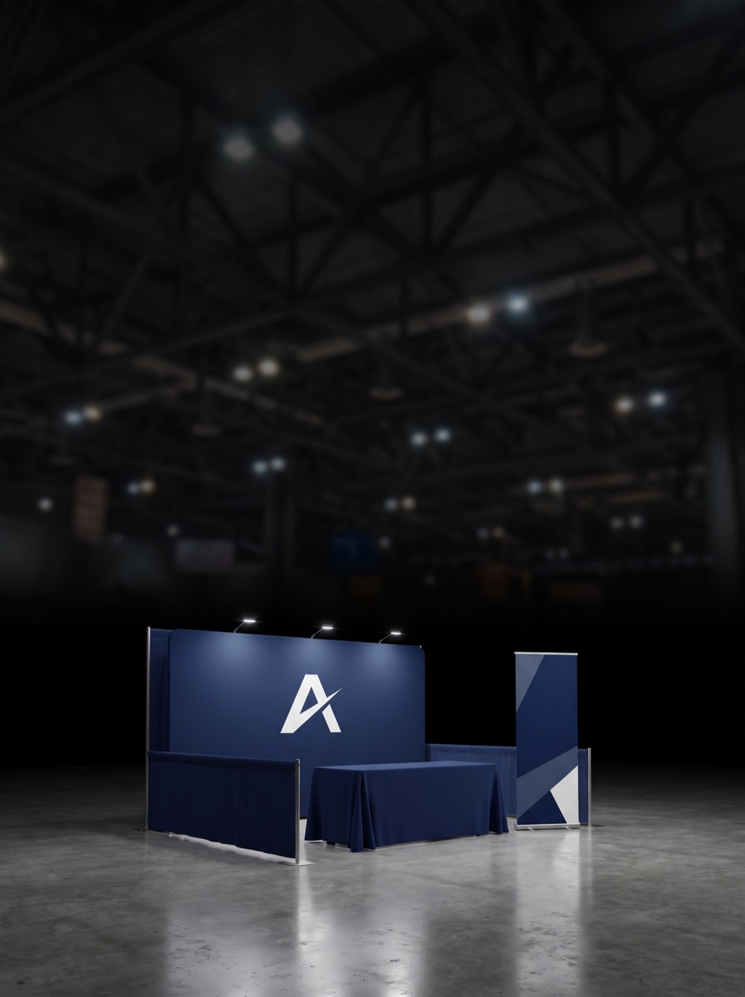 Branded backwall, table cover, and banner stands inside an exhibit hall